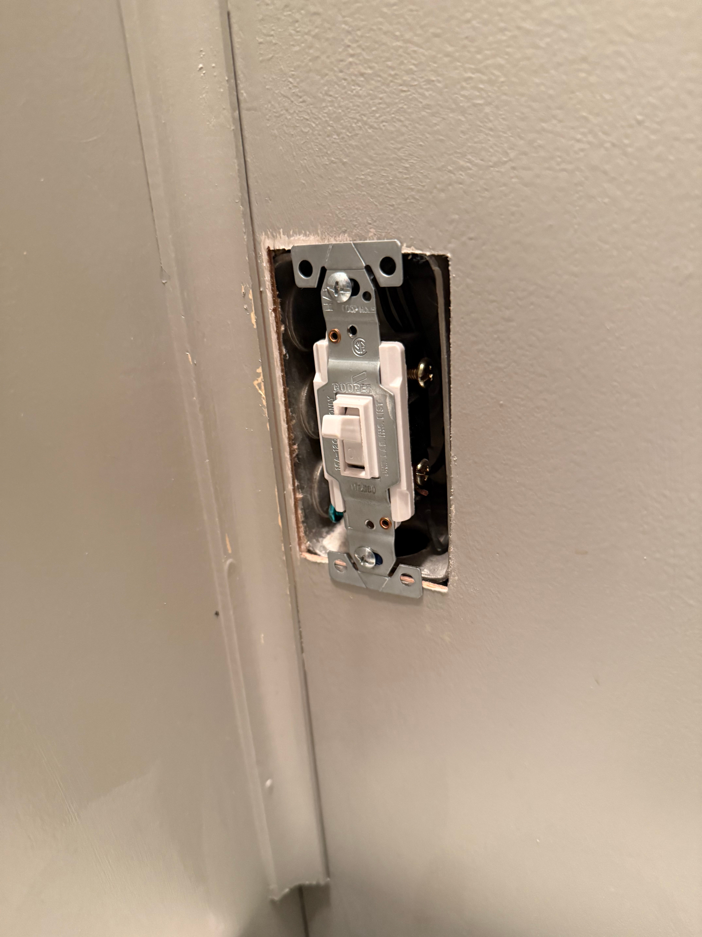 Toggle light switch mounted in a wall box before the cover plate is installed